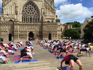 Iyengar yogis, including me, taking part in a flashmob yoga practice in front of Exeter Cathedral.
